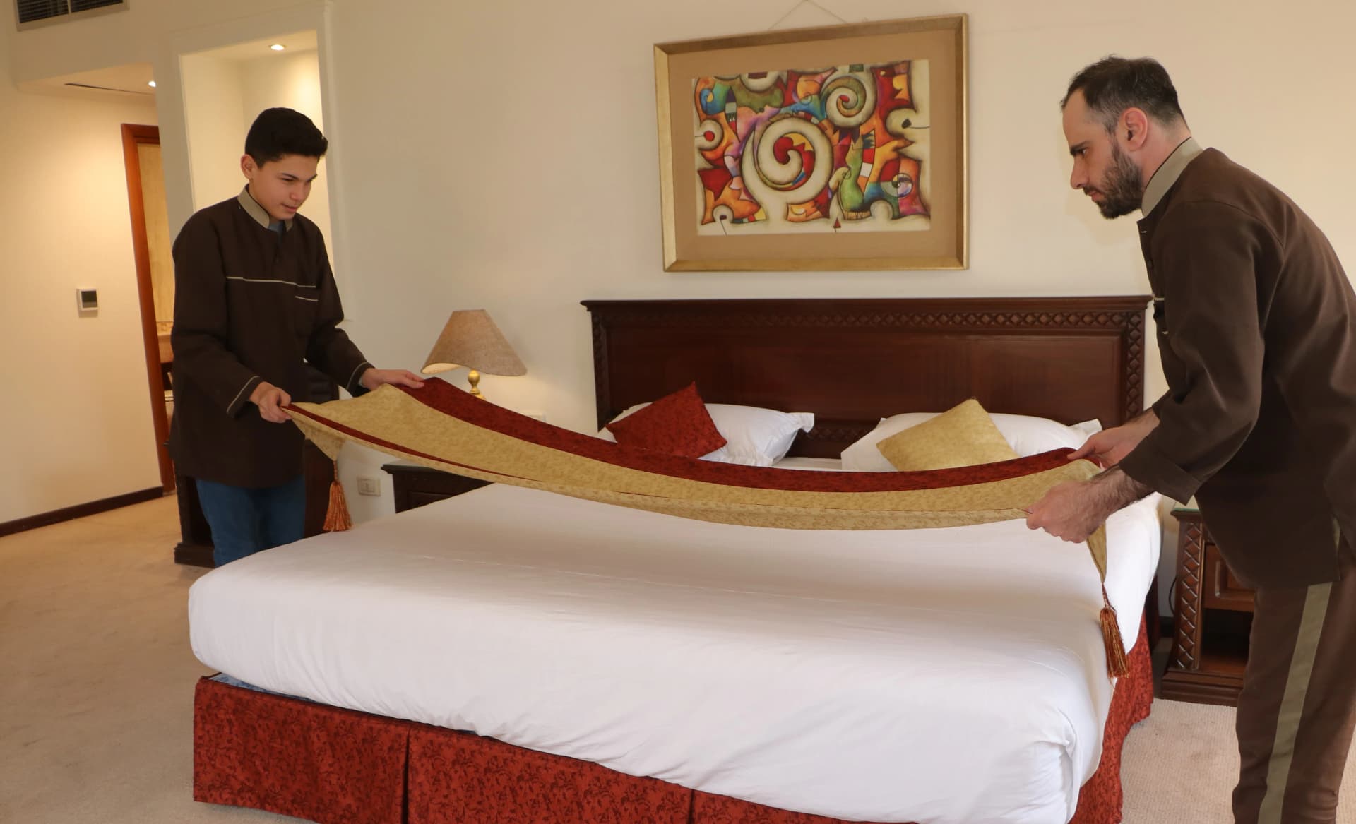 Housekeeping team preparing a guest room at Riga Palace Hotel