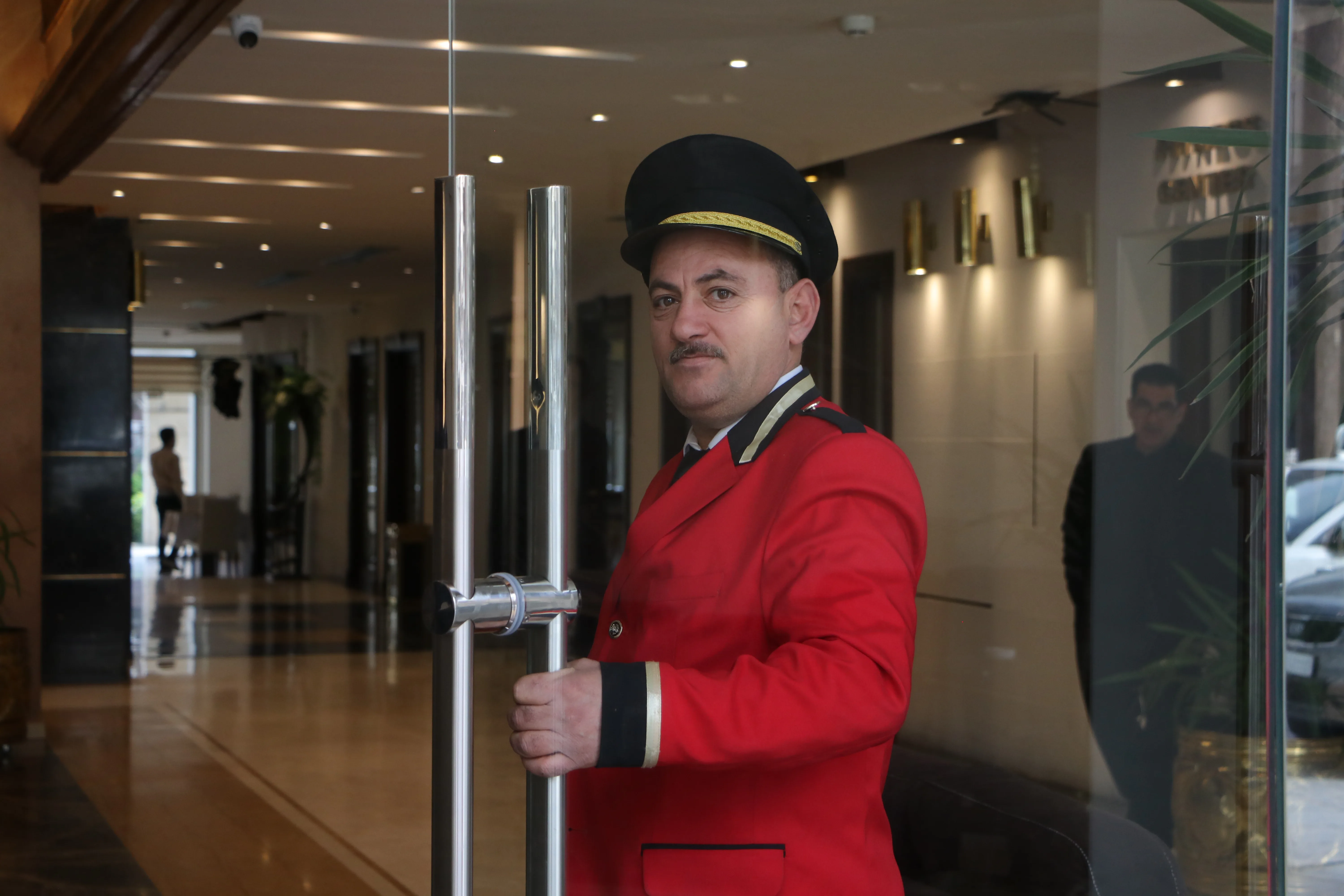 Riga Palace Hotel entrance with doorman welcoming guests
